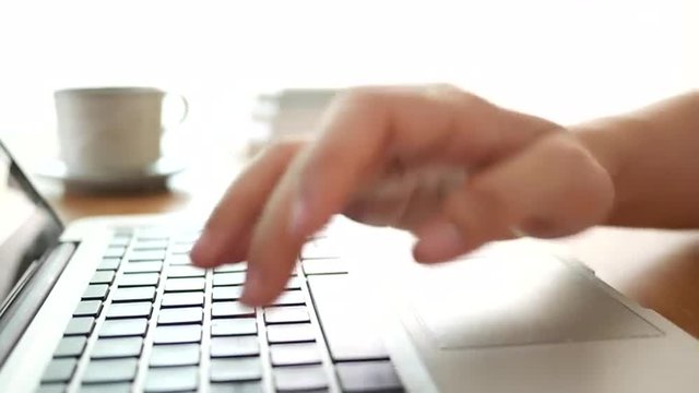 4K Woman's hand keying on laptop keyboard 
