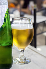 Cold beer on a wooden table in an outdoor restaurant