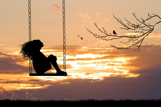girl on swing at sunset