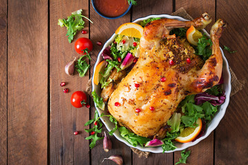 Baked chicken stuffed with rice for Christmas dinner on a festive table