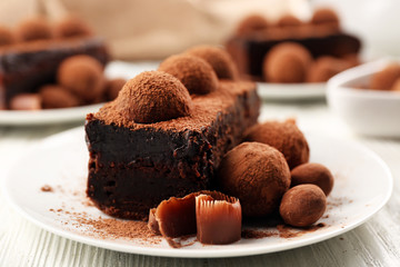Slices of chocolate cake with a truffle on plate closeup