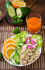 Dietary menu. Breakfast. Oatmeal porridge with vegetables (cucumber, avocado, daikon) and orange