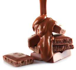 Pieces of chocolate bar and melted topping, isolated on white