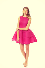 Young blonde woman with pink skirt 