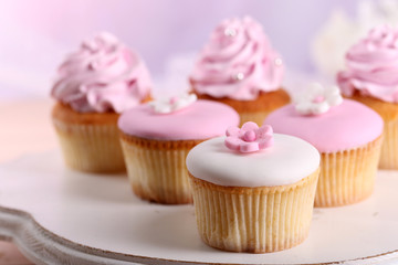Tasty cupcakes on stand, close-up