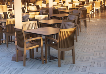 Fototapeta na wymiar Wooden tables in a outdoor restaurant photo