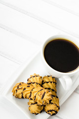 cup of coffee and delicious cakes on a white background