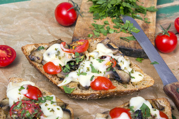 delicious bruschetta with tomatoes, cheese and mushrooms