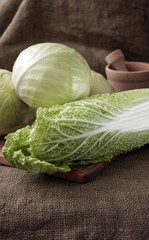cabbage on a wooden board on a background sacking, burlap