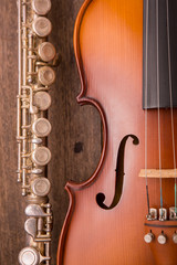 Fototapeta premium violin and flute in vintage style on wood background