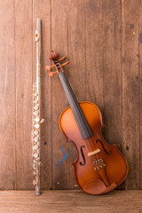 Fototapeta na wymiar violin and flute in vintage style on wood background