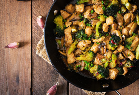 Stir fry chicken with broccoli and mushrooms - Chinese food. 