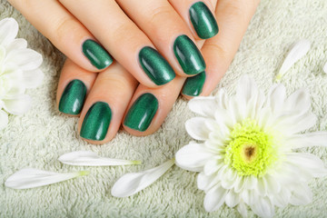 Women's manicure with effect of cat's-eye gel polish on the nail