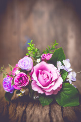 Vintage rose bouquet on wood background