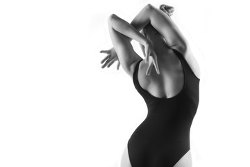 Modern ballet dancer posing on white background