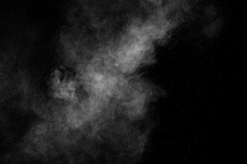 abstract white dust explosion  on a black background. abstract white powder. design elements....