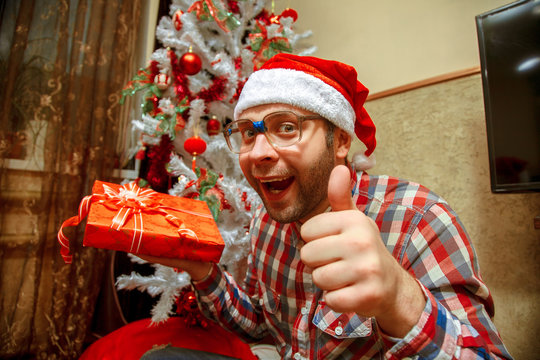 funny nerd in santa hat gets a christmas gifts