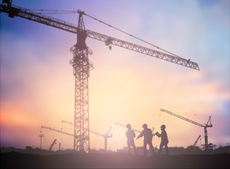 Silhouette man engineer looking construction worker under tower