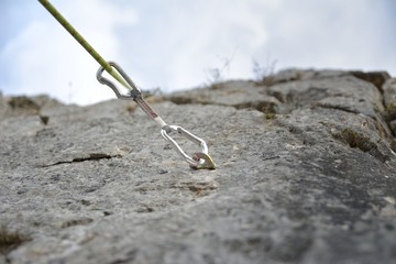 Carbine and hook with rope in stone