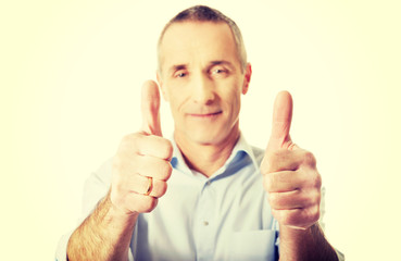 Portrait of mature man gesturing ok sign