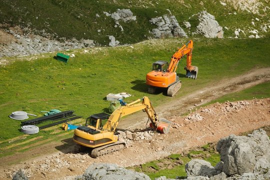 Excavarors working on ski piste