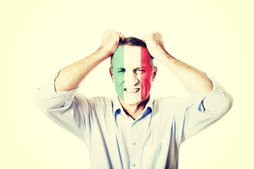 Mature man with Mexico flag on face.