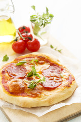 Pizza with salami and oregano
