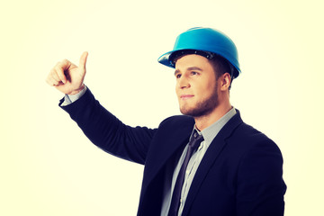 Happy businessman in helmet whit thumbs up.