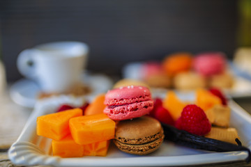 Macaroons - espresso and French dessert, colorful almond cookies with different fruit flavors