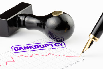 Close-up of bankruptcy stamped on a chart
