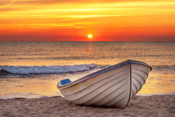 Fototapeta premium Boat on the beach at sunrise time.