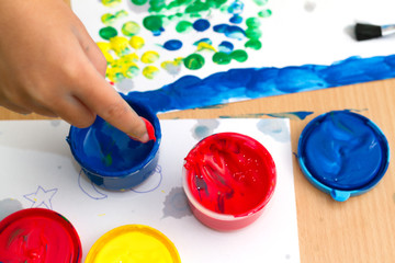 colorful finger paints on a table