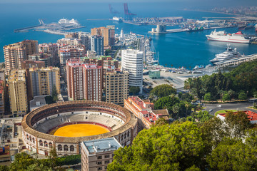 View of Malaga with bullring and harbor. Spain - obrazy, fototapety, plakaty