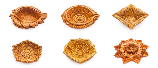 Front view Collage of beautifully carved designer different types of handmade clay lamps isolated on white background.