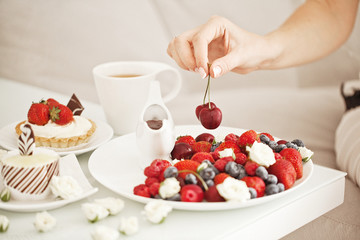 Yummy breakfast - sweet cake with tea and berries - health and non diet concept
