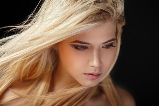 Beautiful young blonde girl with flowing hair.