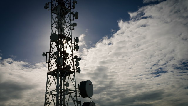 4K communication tower time lapse dark grey moody sky and clouds