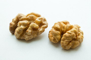 two halves of a walnut on a white background closeup