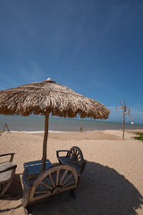 Morning beach with umbrellas made of palm leaves