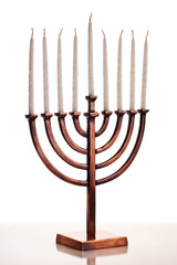 Beautiful unlit hanukkah menorah on white table.