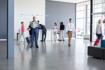 Fototapeta premium Man at airport read newspaper while wait airplane
