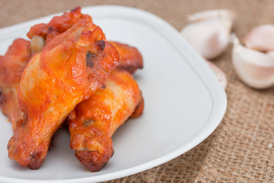 Chicken wings in dish on brown sack.