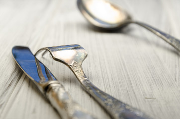 old cutlery on white wooden table