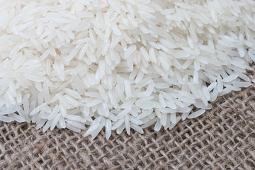 Uncooked white rice (Jasmine Rice)on brown sack.