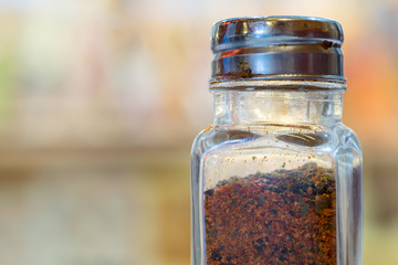 ground dried chillie bottle with Blur background