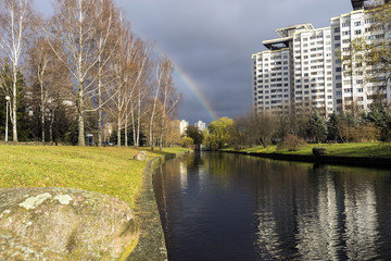 Fototapeta na wymiar rainbow next to the river in the city