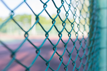 Steel mesh fence with bokeh, use selective focus