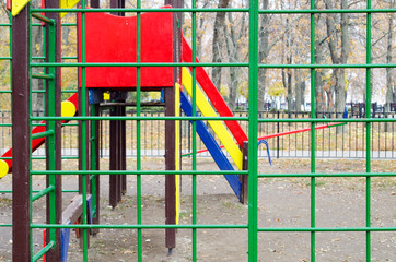 Empty playground in the park against the backdrop of autumn tree