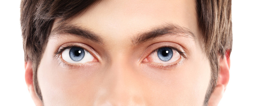 Closeup of blue eyes from a young man red and irritated eye with
