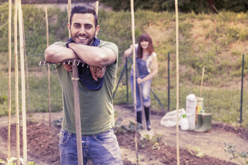 portrait of a young gardener relaxes in her greenhouse